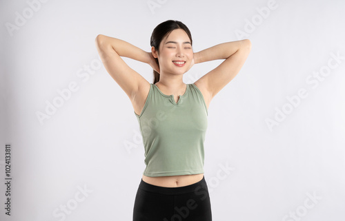 Image of young Asian girl wearing sportswear posing on white background 