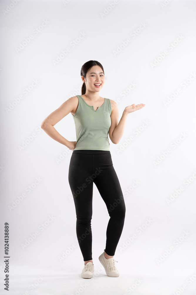Full body image of young Asian girl wearing sports outfit and posing on white background Full body image of young Asian girl wearing sports outfit and posing on white background