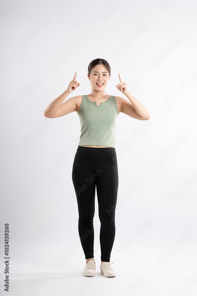 Full body image of young Asian girl wearing sports outfit and posing on white background Full body image of young Asian girl wearing sports outfit and posing on white background