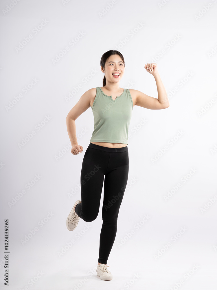 Full body image of young Asian girl wearing sports outfit and posing on white background Full body image of young Asian girl wearing sports outfit and posing on white background