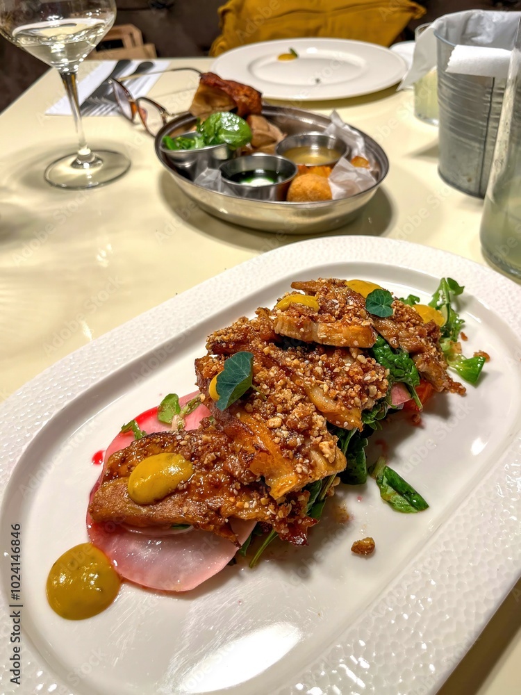 fried pork with yolks and herbs on a tray beautiful presentation