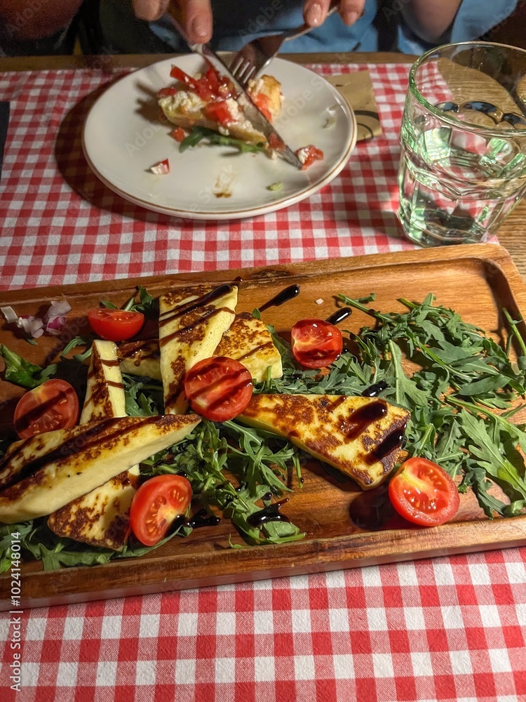 Grilled Halloumi Cheese salad witch orange, tomatoes and lettuce. healthy food