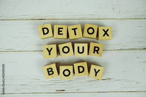 Detox Your Boday with wooden blocks alphabet letters on wooden background