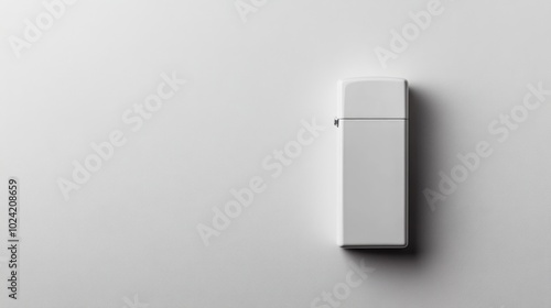 A white, rectangular, blank USB stick is sitting on a white surface.