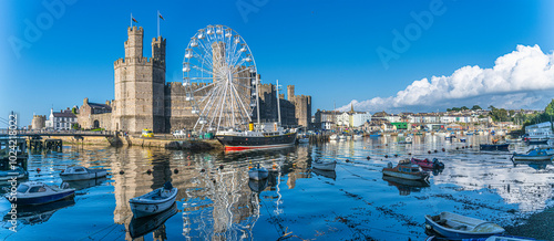 Fototapeta Naklejka Na Ścianę i Meble -  Caernarfon Castle, Gwynedd, Wales, UK - Caernarfon Castle in North West Wales on then banks of Afon Seiont. Built in 1330 it is now a Unesco World Heritage site.