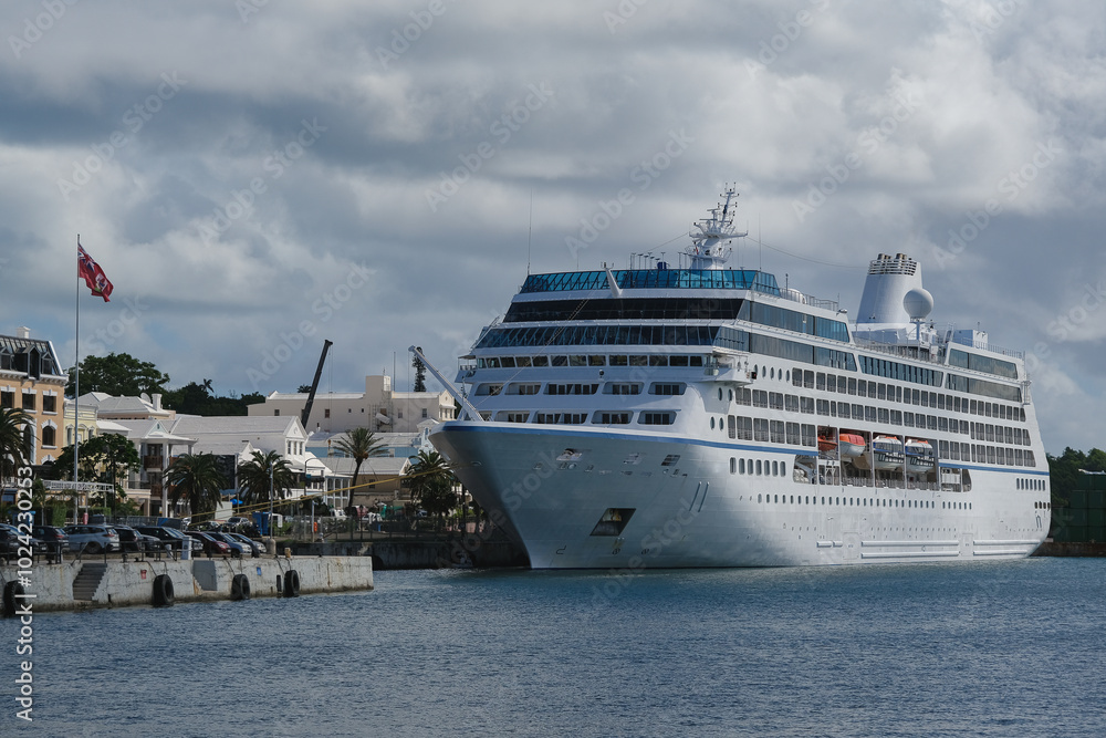 Luxury classic cruiseship cruise ship liner Nautica docked at pier terminal in Hamilton, Bermuda on sunny day with port infrastructure and city skyline Luxury classic cruiseship cruise ship liner Nautica docked at pier terminal in Hamilton, Bermuda on sunny day with port infrastructure and city skyline