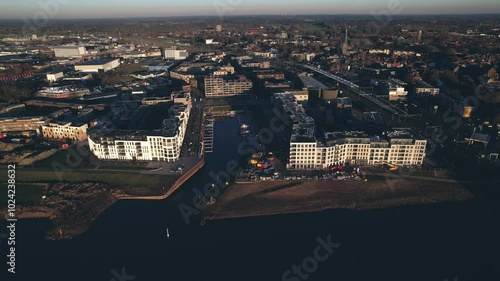 Meadow floodplains and aerial view on PUUR21 new housing construction project part of urban development in Zutphen with Noorderhaven neighbourhood along river IJssel photo