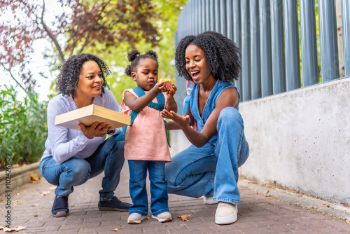 Three generations of african women at the school building entrance photo