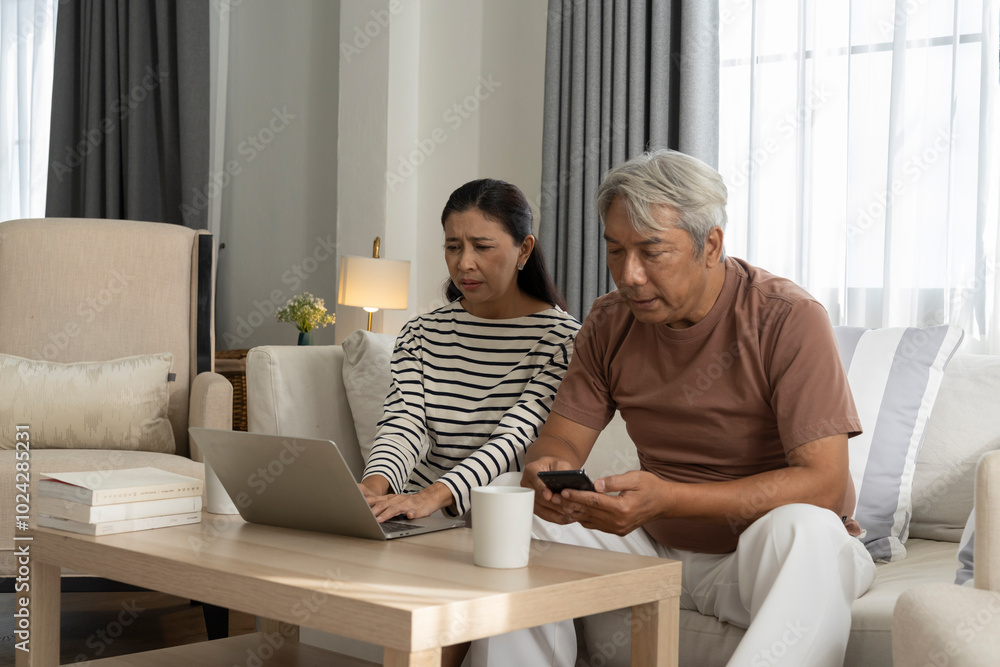 Worried Couple Looking at Laptop Together at Home Worried Couple Looking at Laptop Together at Home