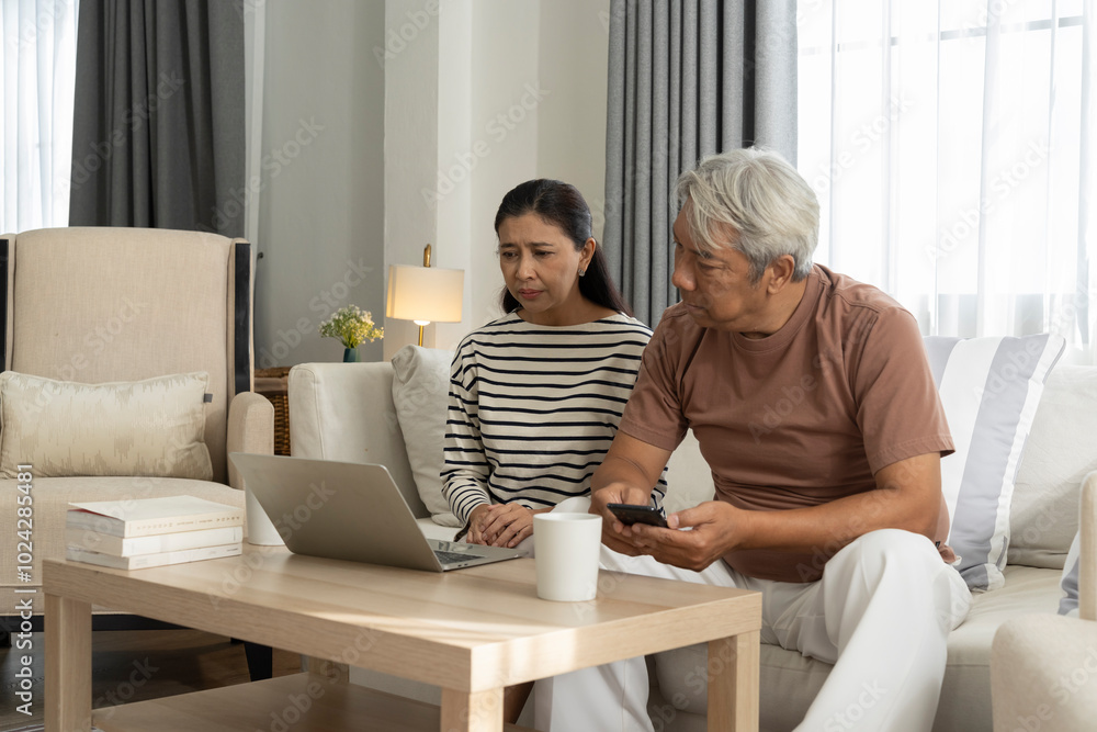 Worried Couple Looking at Laptop Together at Home Worried Couple Looking at Laptop Together at Home