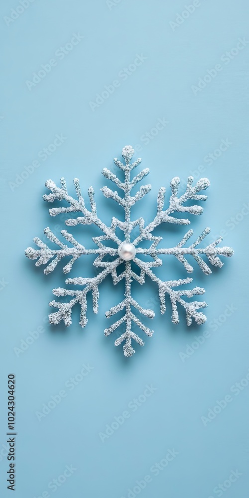 A snowflake with a pearl in the center is on a blue background. The snowflake is made of white beads and has a shiny, sparkling appearance. The pearl adds a touch of elegance A snowflake with a pearl in the center is on a blue background. The snowflake is made of white beads and has a shiny, sparkling appearance. The pearl adds a touch of elegance