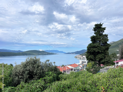 the town of Neum in Bosnia-Herz, its maritime nature and its vegetation. Stroll or walk along the Adriatic Sea, under trees allowing more or less rays of Sun to pass through, in the shade. photo