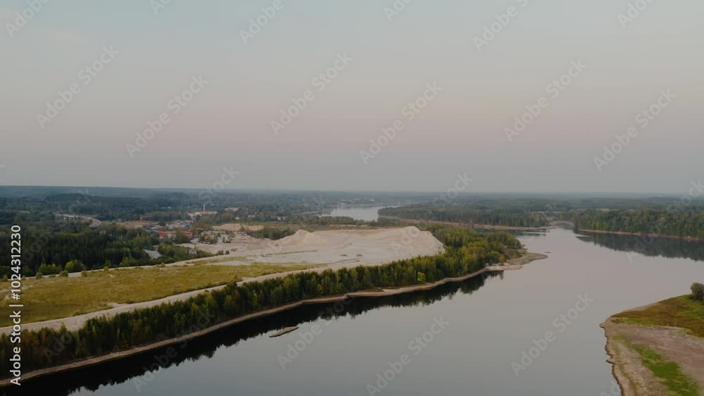 Dolomite mining site from above near river. Aerial view over the river in dusk. Dolomite mining site from above near river. Aerial view over the river in dusk.
