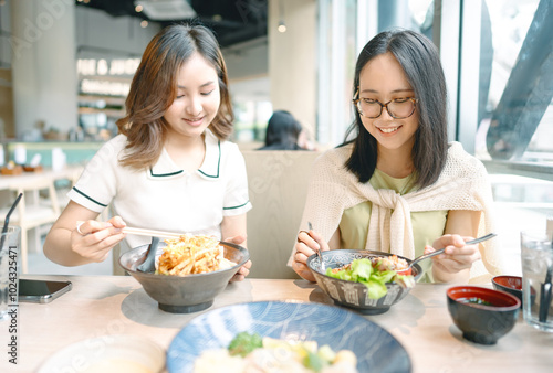 Happy two asian woman eating food at Japanese restaurant asia tasty from traditional culture together