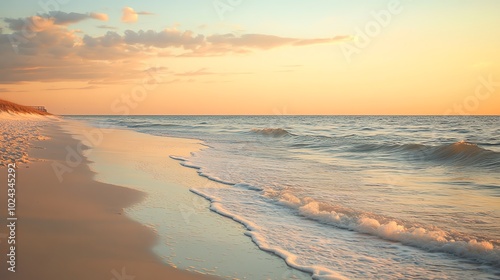 A tranquil beach at sunset with gentle waves lapping at the shore.