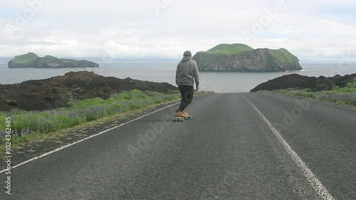 Riding a longboard down road in a beautiful place. Filmed in the Westman Islands, Iceland.