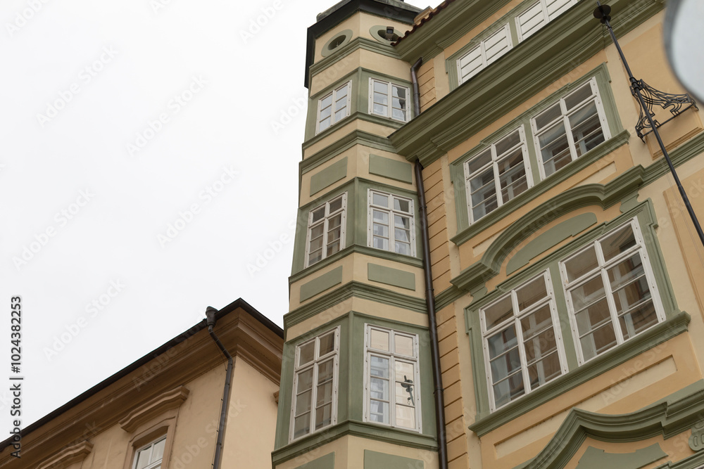 There is a prominent building that features a clock prominently displayed on its exterior side, making it easy to tell the time There is a prominent building that features a clock prominently displayed on its exterior side, making it easy to tell the time