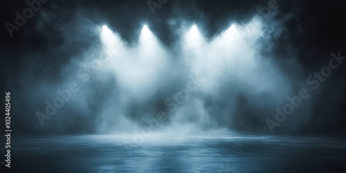 A dark, foggy stage illuminated by intense, bright spotlights. The scene is dramatic and cinematic