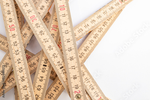 Abstract backdrop with a tangled wooden measuring meter, close up with copy space