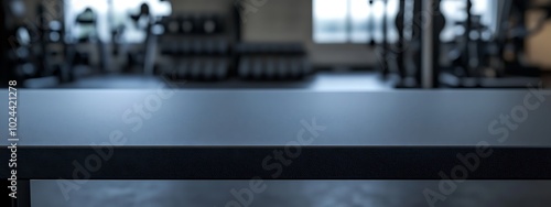  Black table top with gym background for product. Empty countertop mockup for sports nutrition or equipment. 