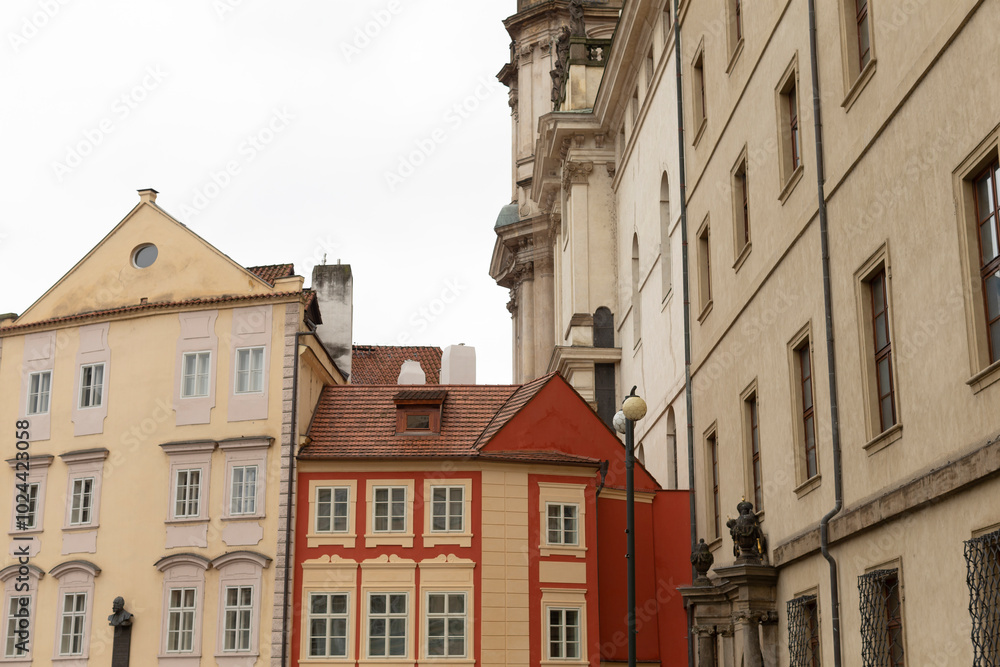 Fototapeta premium There exists a prominent row of buildings, featuring a striking red building right in the center of the lineup, creating a vibrant scene