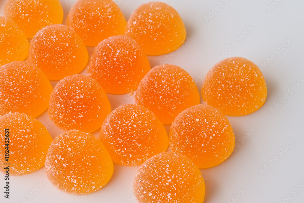 Marmalade in orange on gray . sweet dessert food concept. a round gummy on a gray with oranges and oranges. a round gummy on a white with marmalade and oranges lifestyle. Marmalade in orange on gray . sweet dessert food concept. a round gummy on a gray with oranges and oranges. a round gummy on a white with marmalade and oranges lifestyle.