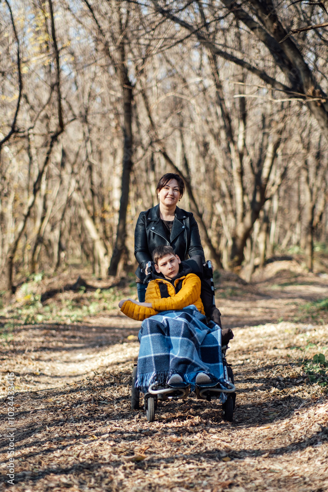 Mother and child with special needs on forest walk, nature therapy, disability inclusion, family bonding, outdoor activities, adaptive equipment. Mother and child with special needs on forest walk, nature therapy, disability inclusion, family bonding, outdoor activities, adaptive equipment.
