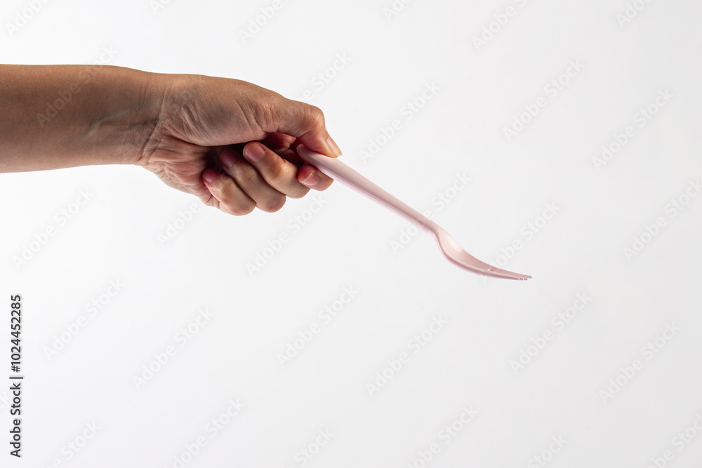 Pink fork and hand isolated on white background. Pink fork and hand isolated on white background.