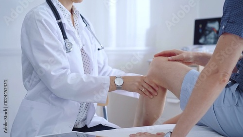 Doctor is carefully examining a patient's knee, providing personalized care and support. Medicine and orthopedic concept