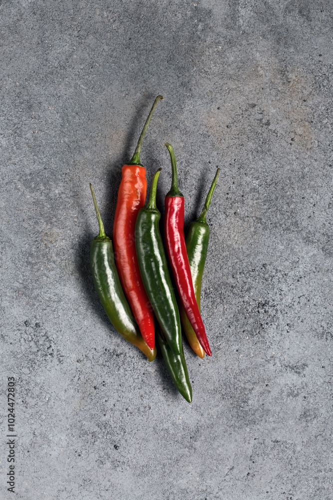 Hot chili pepper on gray textured background, minimalism