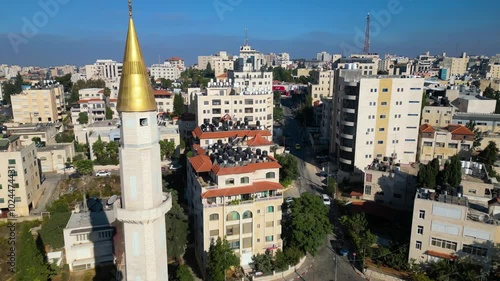 Gold-clad minaret and the skyline of Ramallah, capital of the Palestinian Territories in the occupied West Bank