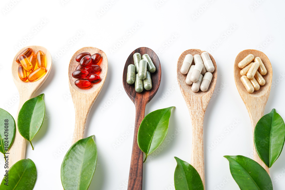 Vitamin capsules in a wooden spoon, soft gels, Fish oil capsules, omega 3, omega 9, vitamin D, vitamin E