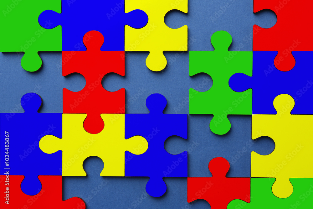 Many colorful puzzle pieces on blue background, top view. Symbol of autism Many colorful puzzle pieces on blue background, top view. Symbol of autism