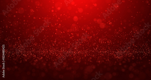 Abstract red background of bright glowing glitter particles and beautiful bokeh.