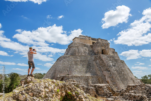 Tourist admiring the mayan ruins of Uxmal, Mexico photo