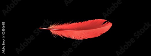 A single red feather floating in the air on a black background