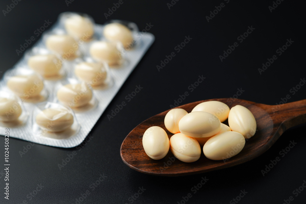 white softgels in wooden spoon, capsules with vitamin E, Cod liver oil, DHA, Fish oil omega 3 white softgels in wooden spoon, capsules with vitamin E, Cod liver oil, DHA, Fish oil omega 3