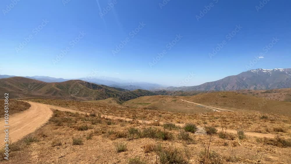 The mountain system of the Western Tien Shan in Uzbekistan. Panorama of the Western Tien Shan on the Angren plateau, Tashkent region. Promising orange mountains in the Western Tien Shan. 4K The mountain system of the Western Tien Shan in Uzbekistan. Panorama of the Western Tien Shan on the Angren plateau, Tashkent region. Promising orange mountains in the Western Tien Shan. 4K