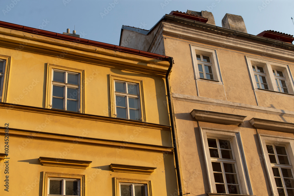 There are two yellow buildings prominently displayed, set against a vivid blue sky that serves as a picturesque backdrop There are two yellow buildings prominently displayed, set against a vivid blue sky that serves as a picturesque backdrop