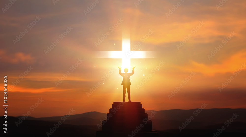 Praying, blessing and expressing faith in God of Christianity. Silhouette of businessman standing on stairs with symbol holy cross on sunset background. Religious concepts of blessing, hope, and help. Praying, blessing and expressing faith in God of Christianity. Silhouette of businessman standing on stairs with symbol holy cross on sunset background. Religious concepts of blessing, hope, and help.