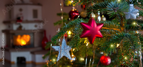 Christmas and New Years background with fir tree and blur burning fireplace .