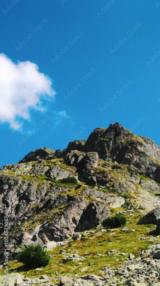Landscape of rocky mountain top with blue sky and clouds Landscape of rocky mountain top with blue sky and clouds