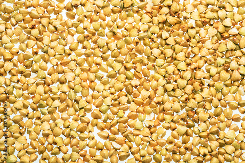 Hulled kernels of buckwheat grains close up. Food background. Hulled kernels of buckwheat grains close up. Food background.