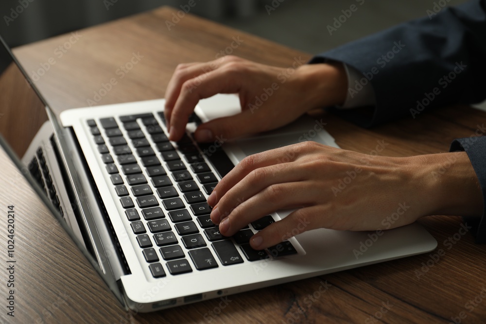 Businesswoman using laptop at wooden table indoors, closeup. Modern technology Businesswoman using laptop at wooden table indoors, closeup. Modern technology
