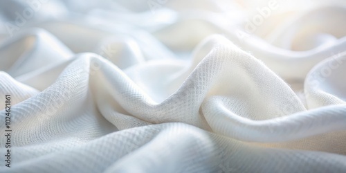 The delicate texture of white fabric with subtle wrinkles and soft light reflections creating a sense of pureness and simplicity