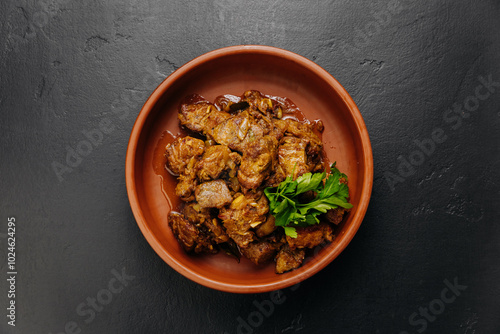 Top view of homemade roasted meat with onions, herbs. Perfect for food blogs, cookbooks, and menus photo