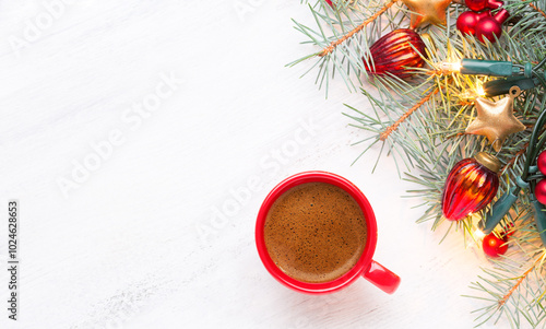 Obraz na płótnie Red cup with coffee and fir branch with Christmas decorations and glowing garland on old wooden shabby white table with empty space for text. Top view. w salonie
