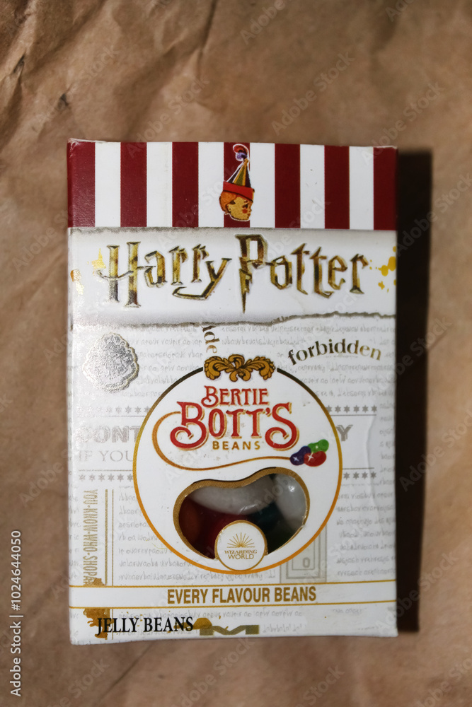 Fototapeta premium Kyiv, Ukraine. 10.10.2024:Bertie Botts Every Flavor Beans box displayed on brown packaging in a warm setting. Stock editorial photo.