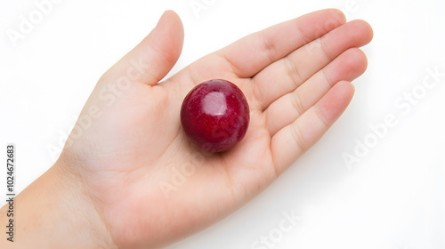 Top view of a berry resting on an open palm isolated on a white background 