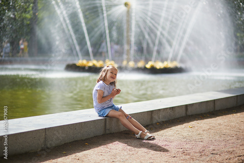фотографія Adorable preschooler girl walking in Petergof, St